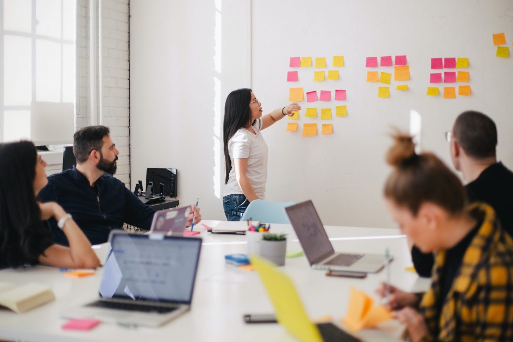 People sticking notes to whiteboard